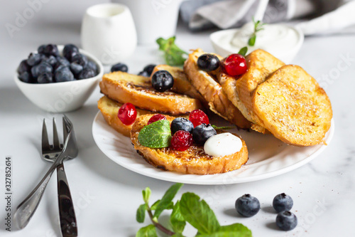 Traditional sweet French toasts with blueberry, dried cherry, mint and coffee. Delicious breakfast. 