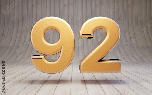 Golden number 92 on wooden floor.