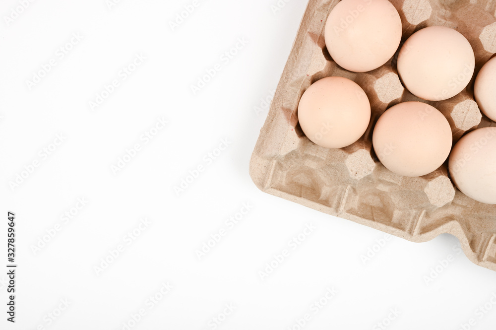 A tray with eggs on a white table. eco tray with eggs on a white background, the trend of minimalism, top view. Egg tray A tray with eggs on a white table. eco tray with eggs on a white background, the trend of minimalism, top view. Egg tray