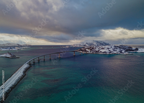 Wallpaper Mural drone view of Sommaroy bridge in Norway and the snowstorm in the distance which clouded the sky and the transparent turquoise water Torontodigital.ca