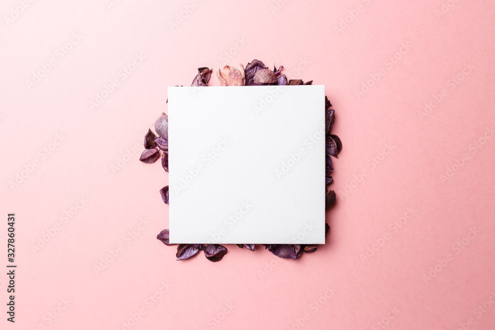 Frame made of purple and pink dry flowers, branches, leaves and petals on pastel pink background. Colorful background image. Top view. Flat lay. Copy space. Art concept. Color trends 2020