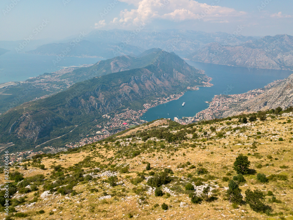 Aerial view of the Bay of Kotor, Boka. Scenic road overlooking the bay of the Kotor fjord. Winding roads to discover Montenegro. Tourism and cruise ships