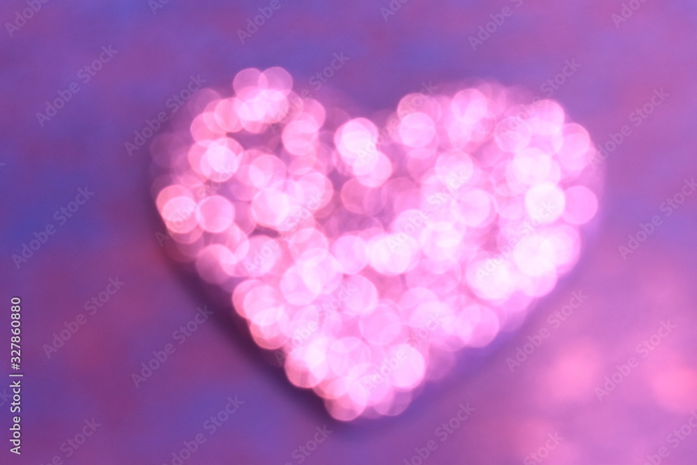 Abstract blurred pink heart on a lilac background.