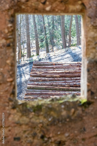 a wall with windows overloocking a wooden heap photo