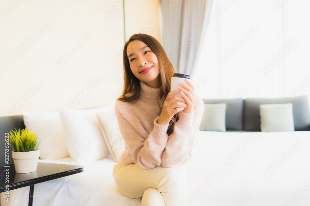 Portrait beautiful young asian woman with coffee cup and mobile phone on bed Portrait beautiful young asian woman with coffee cup and mobile phone on bed