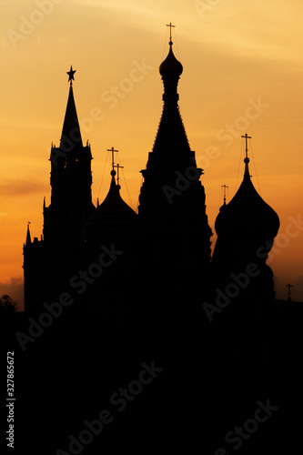 Black silhouette of Cathedral of Vasily the Blessed, Spasskaya Tower and Kremlin. Sunset sky.