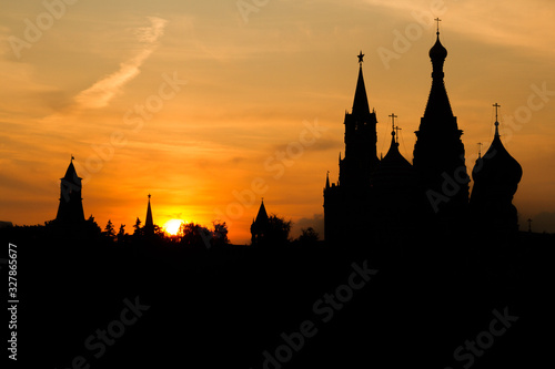 Black silhouette of Cathedral of Vasily the Blessed, Spasskaya Tower and Kremlin. Sunset sky.