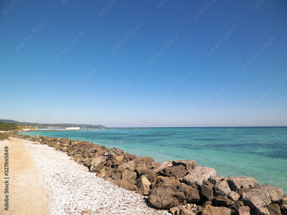 Breakwater on beach in Vada, Italy.