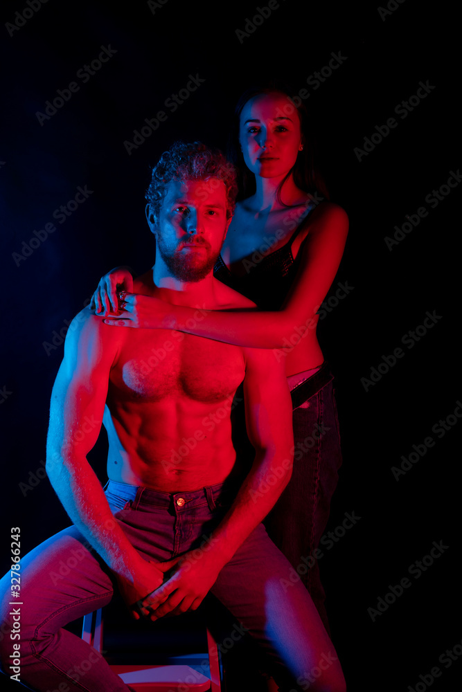 Young couple, sportsman man and tender woman. Concept Young couple, sportsman man and tender woman. Concept