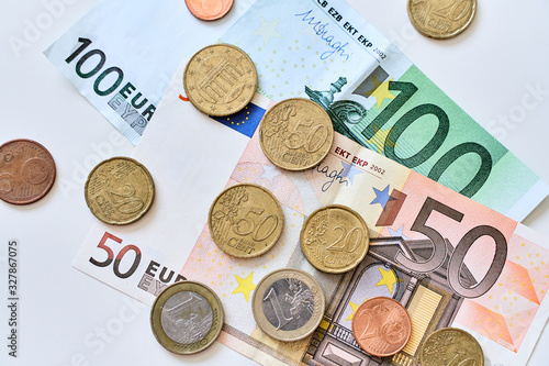 Calculation of expenses. Cash money. 100 and 50 Euro banknotes with coins. Top view.