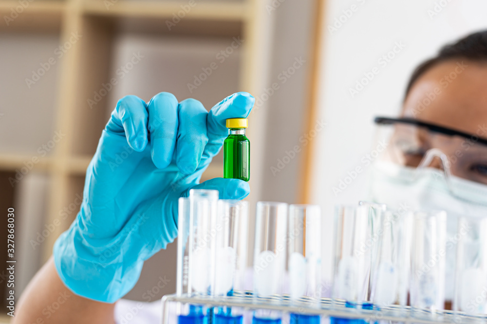 Doctors or scientists prepare a vaccine to prevent a new strain of influenza to inject the patient to create immunity in the body, Vaccinate concept. Doctors or scientists prepare a vaccine to prevent a new strain of influenza to inject the patient to create immunity in the body, Vaccinate concept.