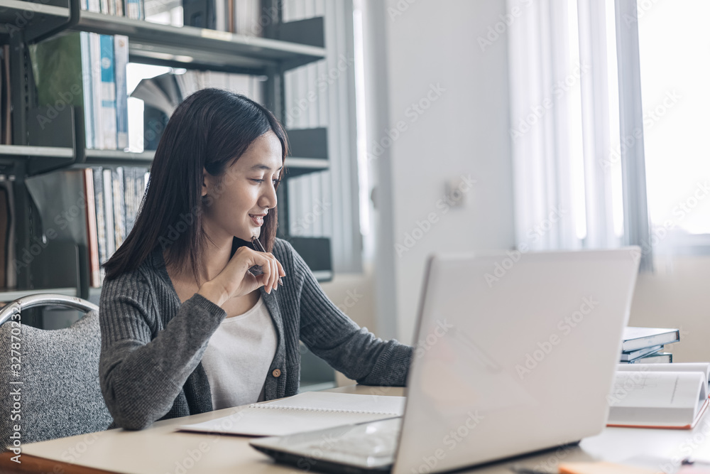 High school or college students studying and reading text on laptop. High school or college students studying and reading text on laptop.