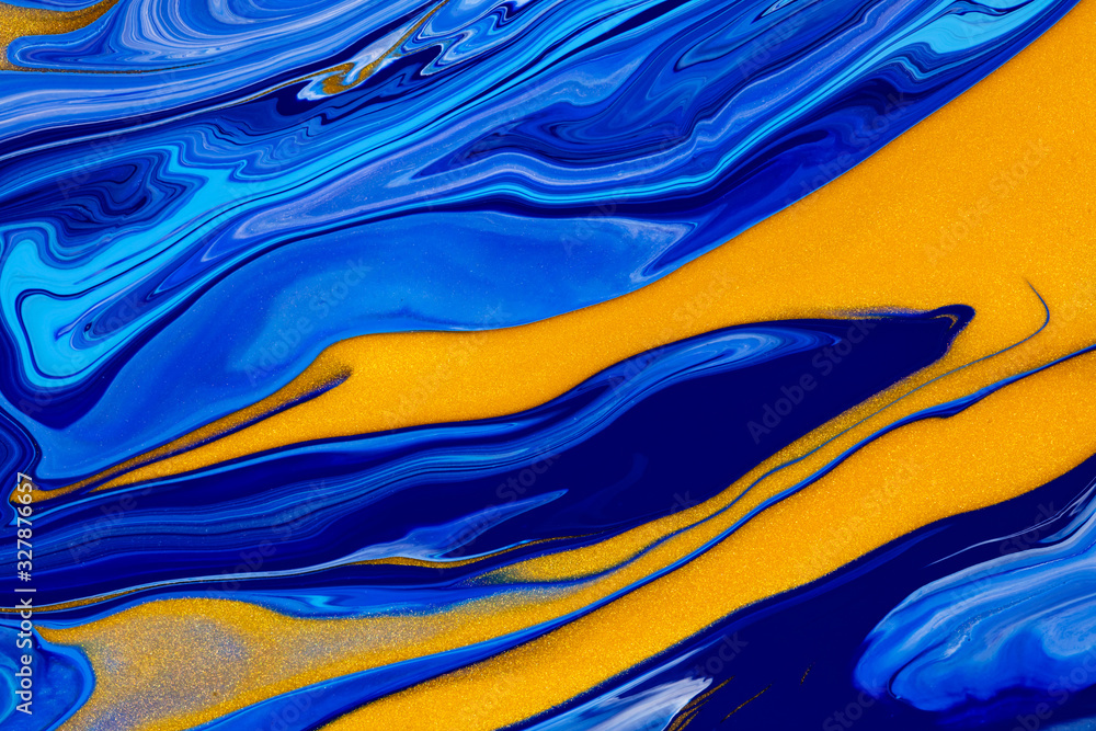 Fluid art texture. Background with abstract mixing paint effect. Liquid acrylic picture that flows and splashes. Mixed paints for posters or wallpapers. Blue, golden and cyan overflowing colors
