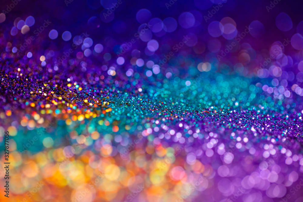 Festive twinkle glitters background, abstract sparkle backdrop with  circles,modern design overlay with sparkling glimmers. Yellow, blue, purple  and green backdrop glittering sparks with glow effect Stock Photo