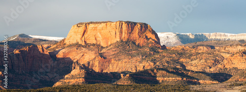 Burnt mountain and Kolob fingers glow in the evening light of a winter day with the snow covered plateau of Kolob mountain behind them.
