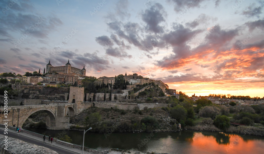 Panoramic view of Toledo at sunset, with the Alcazar de Toledo in the background