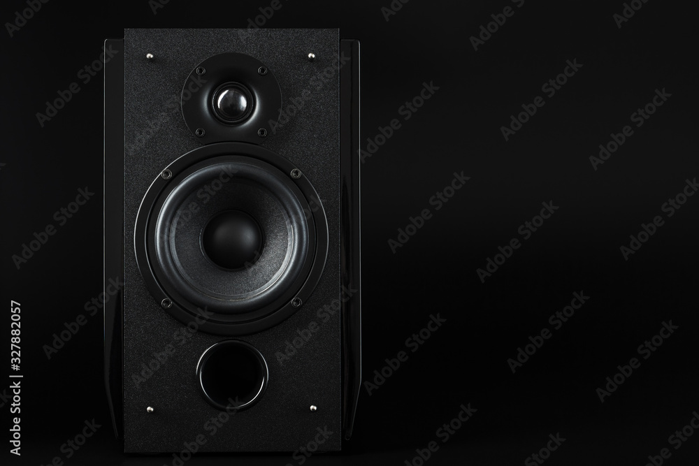 Multimedia speaker column on a black background. Free space for text. Multimedia speaker column on a black background. Free space for text.