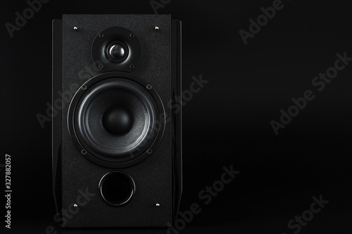 Multimedia speaker column on a black background. Free space for text.