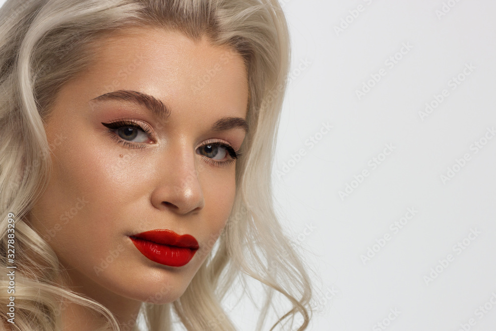 Closeup portrait of a woman with developing straight hair. Sweet tender young girl blonde. Red lipstick, transparent clean skin. Skin care natural cosmetics in the spa salon or cosmetology. Closeup portrait of a woman with developing straight hair. Sweet tender young girl blonde. Red lipstick, transparent clean skin. Skin care natural cosmetics in the spa salon or cosmetology.