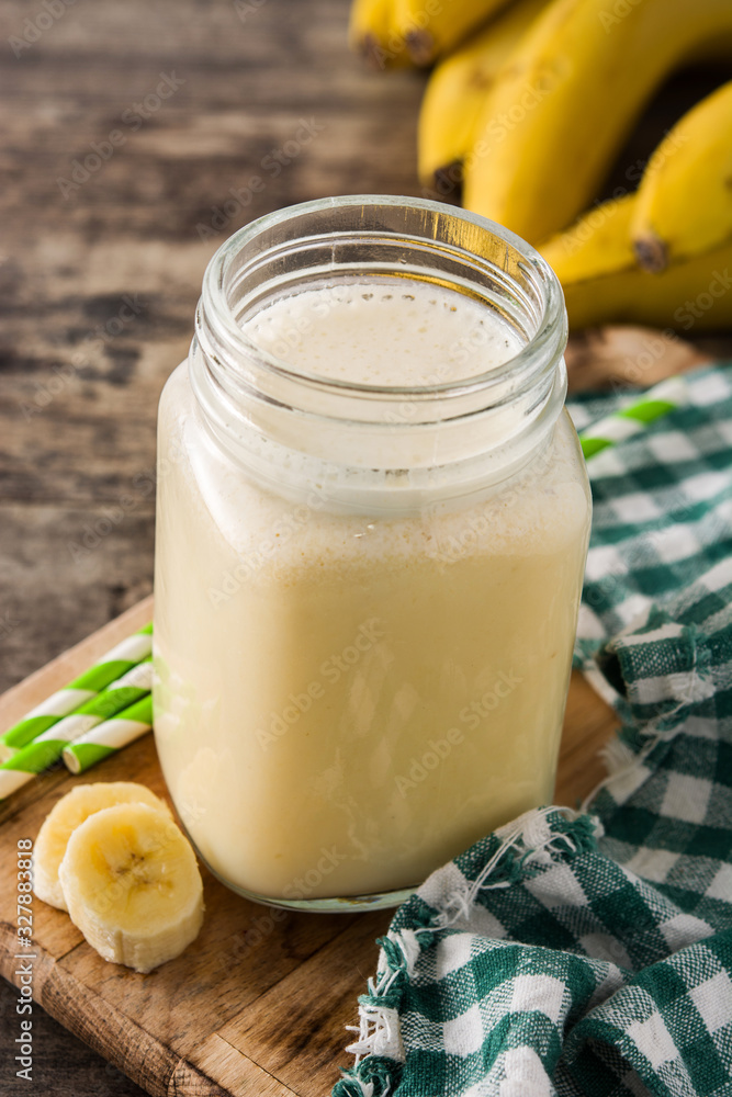 Banana smoothie in jar on wooden table Banana smoothie in jar on wooden table