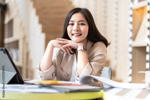 Architect or interior designer working with material sample board in showroom. Business of Real estate, home decoration .Creative people workplace. young designer woman working .