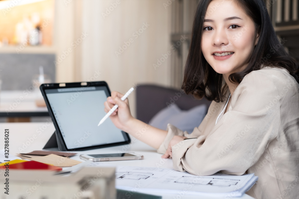 Architect or interior designer working with material sample board in showroom. Business of Real estate, home decoration .Creative people workplace. young designer woman working. Architect or interior designer working with material sample board in showroom. Business of Real estate, home decoration .Creative people workplace. young designer woman working.