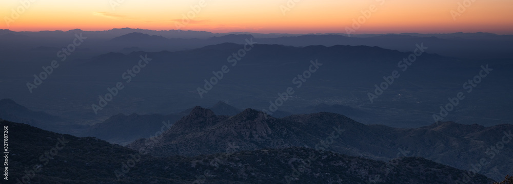 Colorful orange sunset from Kitt Peak Observatory over Arizona desert hills
