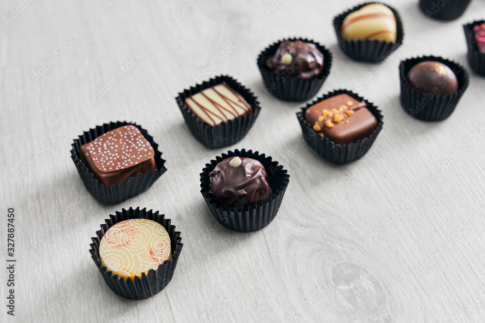 Different chocolate candies on wooden table. Different chocolate candies on wooden table.