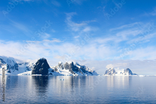 Snow-capped mountains and icy coasts at the entrance to the Lemaire Channel in the Antarctic Peninsula, Antarctica