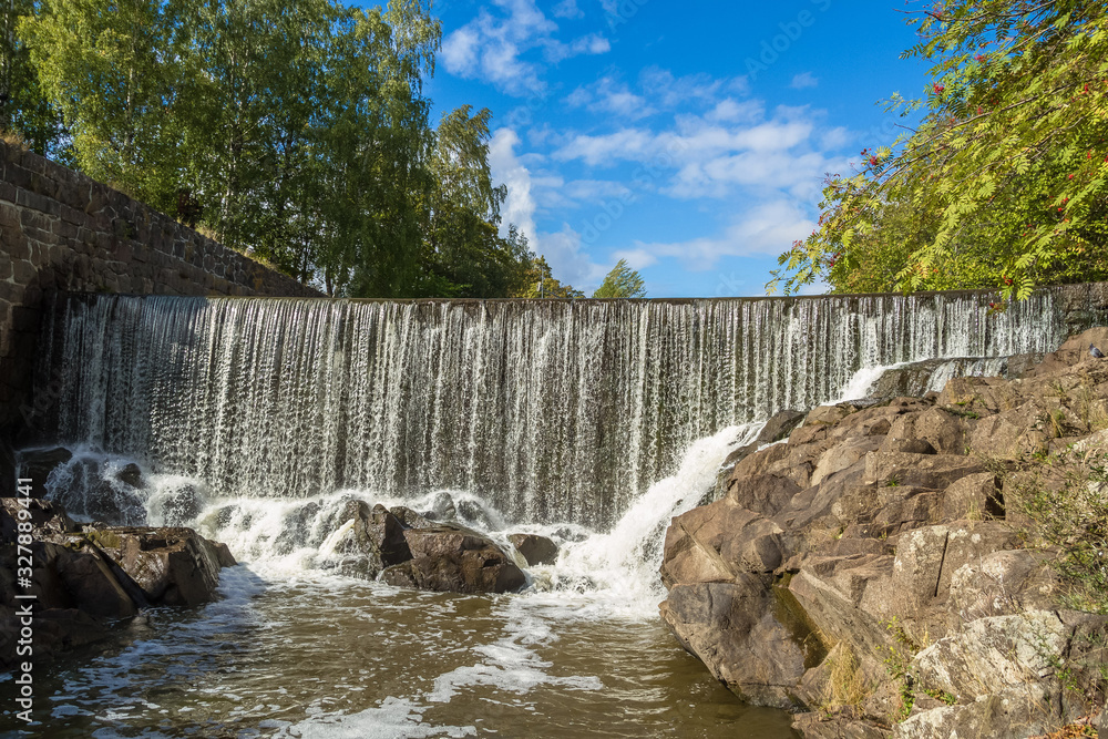 The picturesque view of Vanhakaupunki, the oldest part of Helsinki. The artifical waterfall of the hydroelectric power station