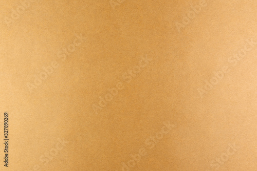 Brown background of real colored paper, illuminated by a soft light on the sides.