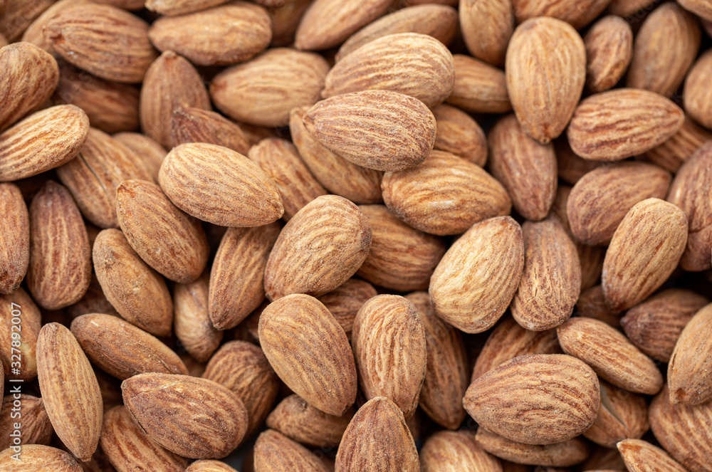 Fototapeta premium Brown almond nuts background texture.
