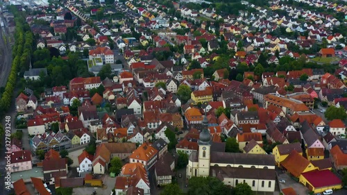 Aerial view from the old part of the city Lauda-Königshofen in Germany.  Panorama view, camera tilts down to view of baroque Church of St. Jakobus. Railroad tracks run along the left. photo