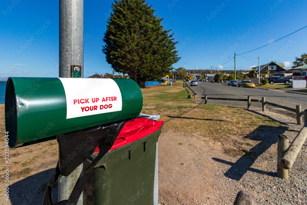 A dog waste bag dispenser at the waterfront of Bell Bay, Tasmania, Australia A dog waste bag dispenser at the waterfront of Bell Bay, Tasmania, Australia