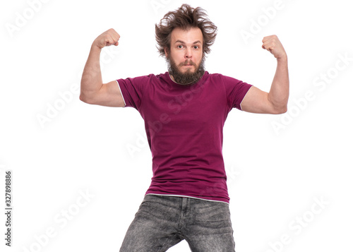 Crazy bearded Man with funny Haircut raised his hands and shows biceps. Serious handsome guy, isolated on white background. Strong male flexing biceps and looking at camera.