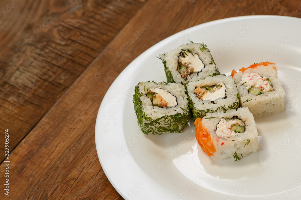 rolls with dill and salmon with soy sauce, ginger and chopsticks. rolls with dill and salmon with soy sauce, ginger and chopsticks.