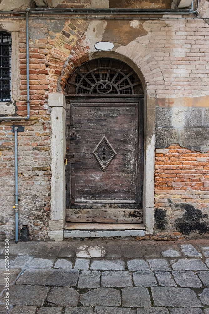 Old wooden door and wall weathered by age