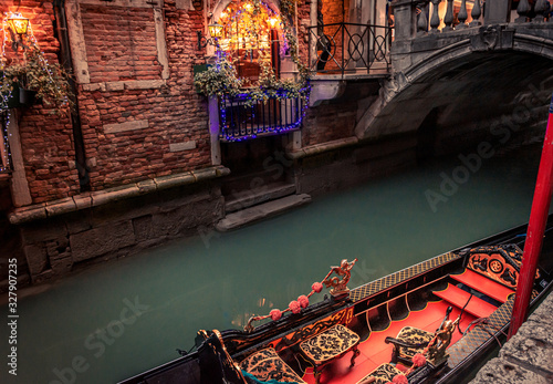 Obraz na płótnie moored gondola on narrow canal with bridge and christmas lights w salonie
