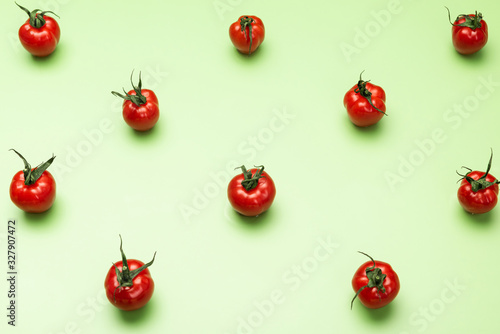 Red Tomatoes Geometric Pattern on Green Background. Flat Lay Design © marcin jucha
