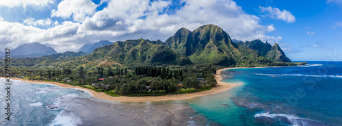 Aerial panoramic image off the coast over Tunnels beach on Hawaiian island of Kauai with Na Pali mountains behind