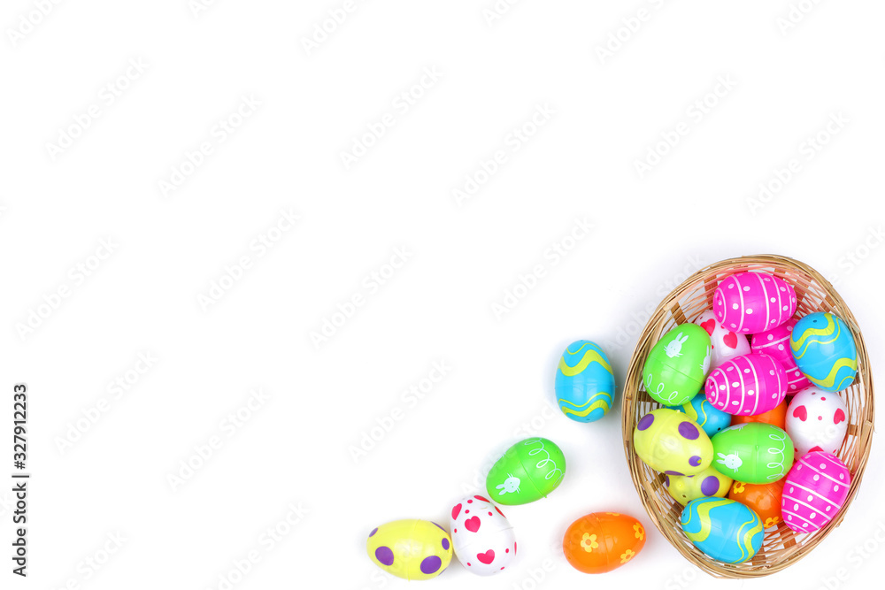 Basket of childs plastic easter eggs on white with copy space Basket of childs plastic easter eggs on white with copy space