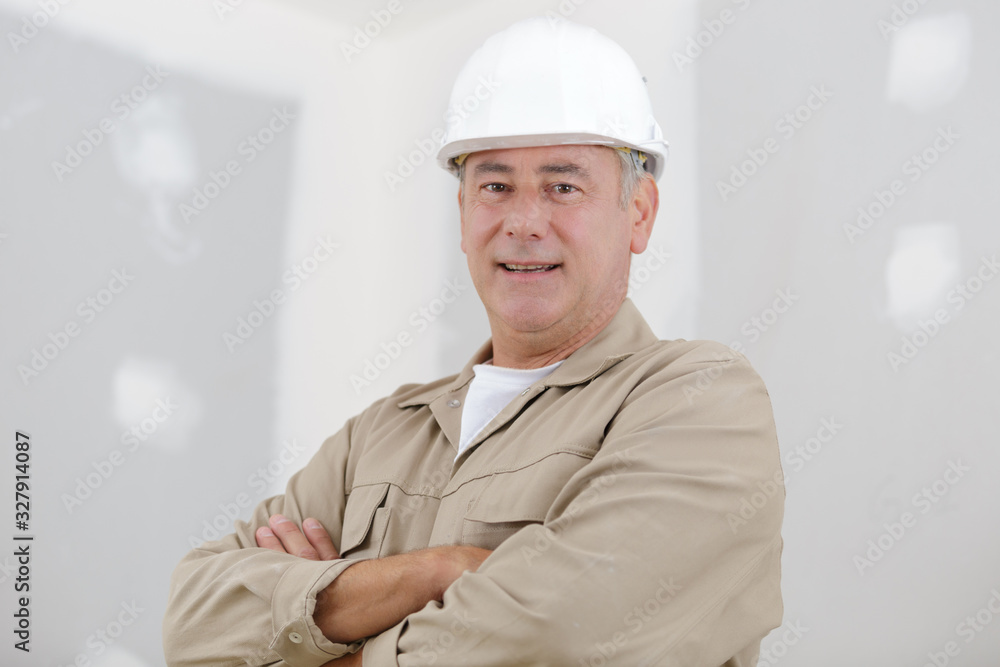 a man builder standing indoors a man builder standing indoors