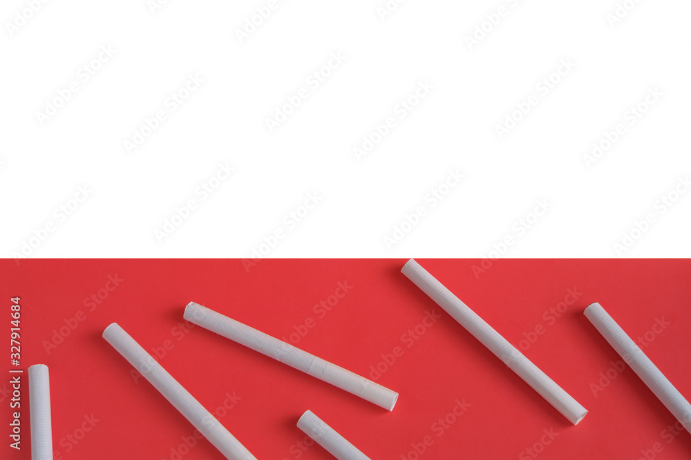 Scattered cigarettes on a light pink background, symbolizing the dangers of smoking. Scattered cigarettes on a light pink background, symbolizing the dangers of smoking.