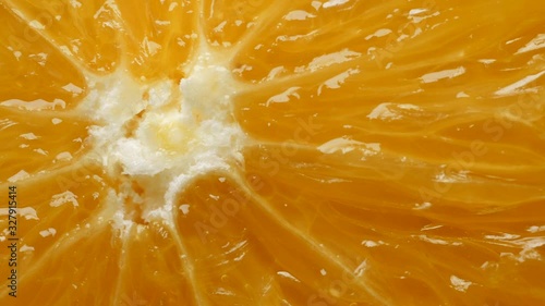 Fresh yellow organic orange slice in extreme close up macro