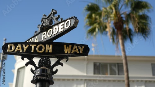 World famous Rodeo Drive symbol, Cross Street Sign, Intersection in Beverly Hills. Touristic Los Angeles, California, USA. Rich wealthy life consumerism, Luxury brands and high-class stores concept photo