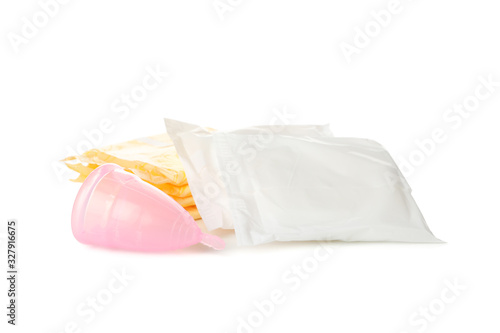 Packaged sanitary pads and menstrual cup isolated on white background