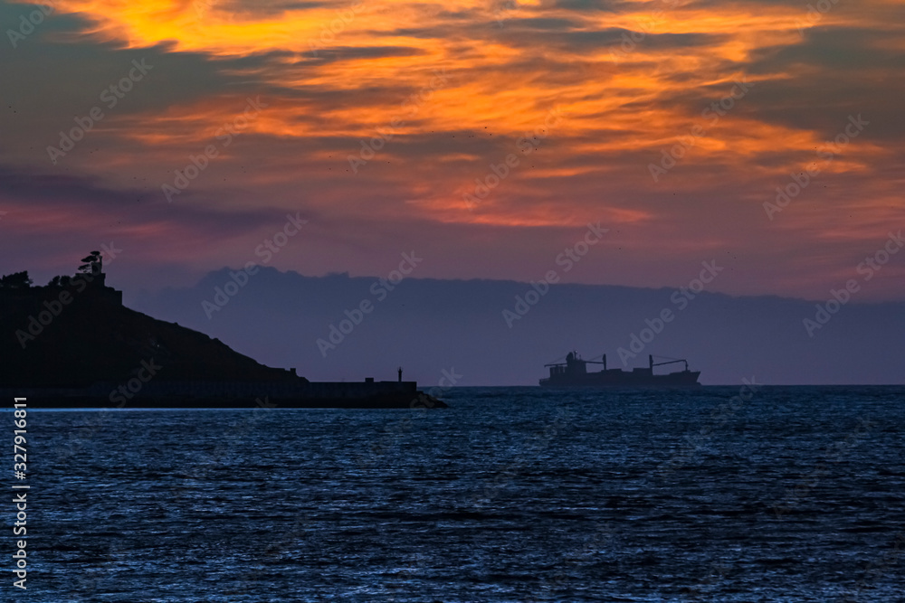 sunset landscape with a freighter sailing