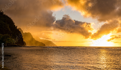 Sunset lights the receding cliffs of the NaPali coastline on north coast of Kauai in Hawaii photo