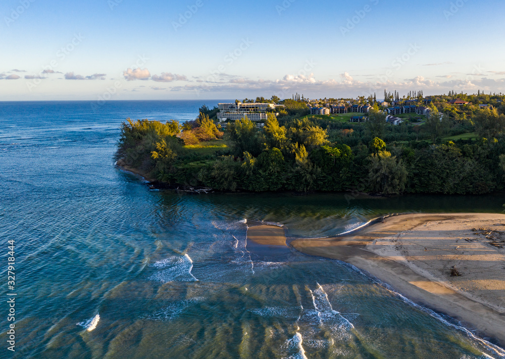 Aerial panoramic image at sunrise off the coast over Hanalei Bay and Princeville on Hawaiian island of Kauai