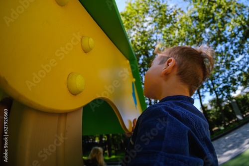 Happy boy on playground, su...